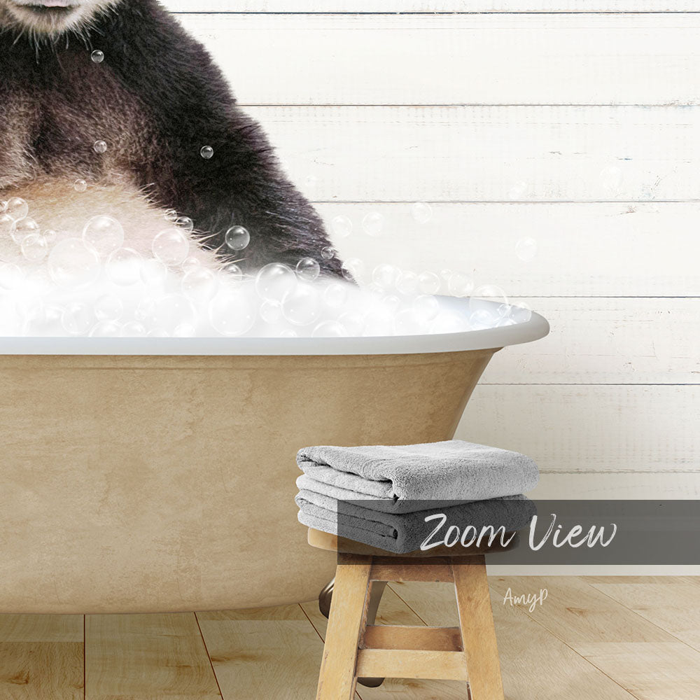A panda sitting in a bathtub filled with bubbles, with a towel and stool visible in the foreground.