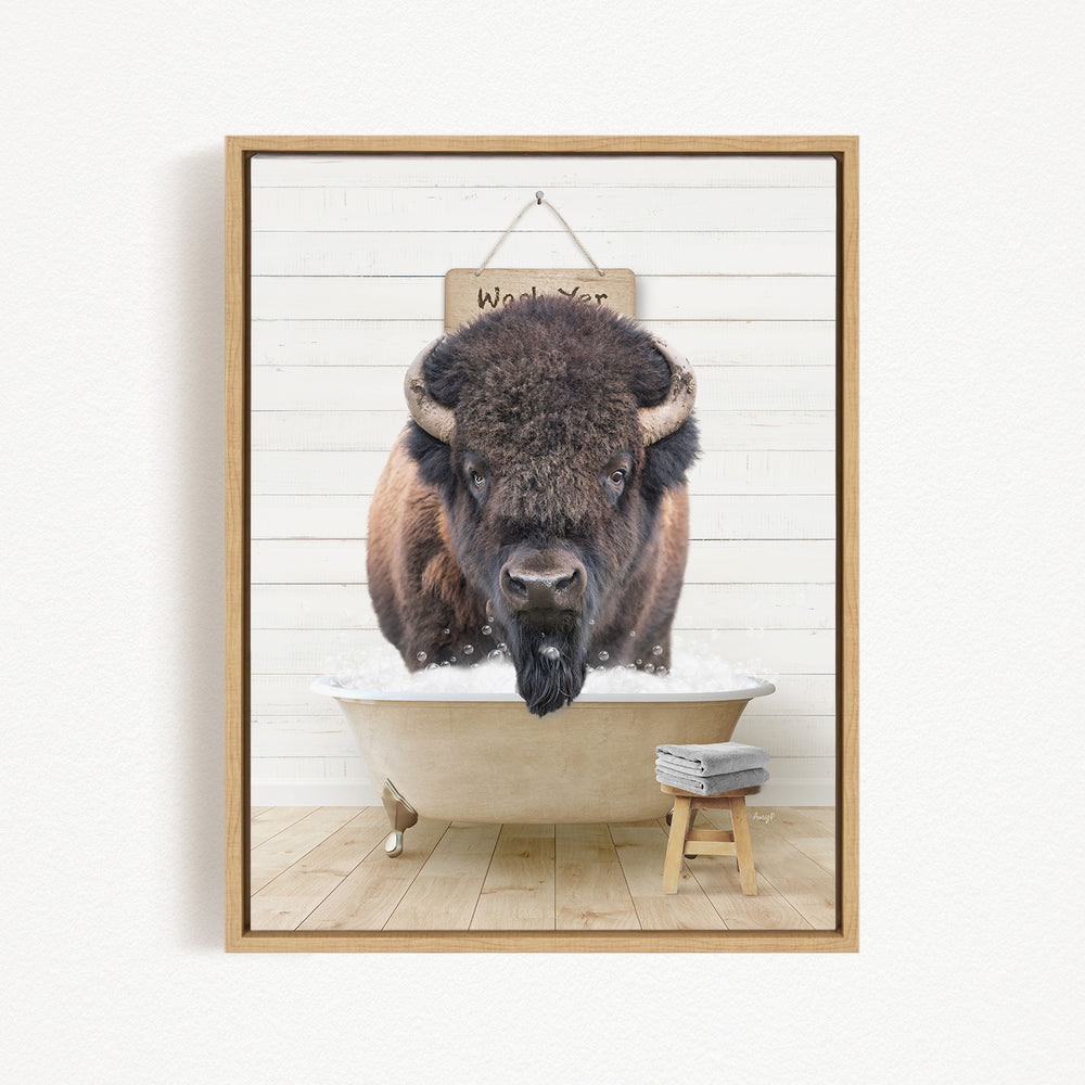 A buffalo is sitting in a bathtub, with a sign above it that says "Wash Your Bison".