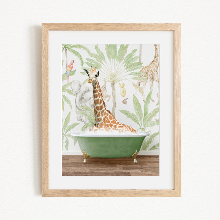 A giraffe is sitting in a green bathtub, surrounded by tropical foliage, in the image.