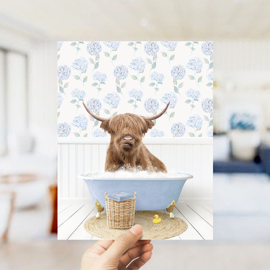 A brown cow with horns is sitting in a blue bathtub filled with bubbles, surrounded by a floral patterned wall.