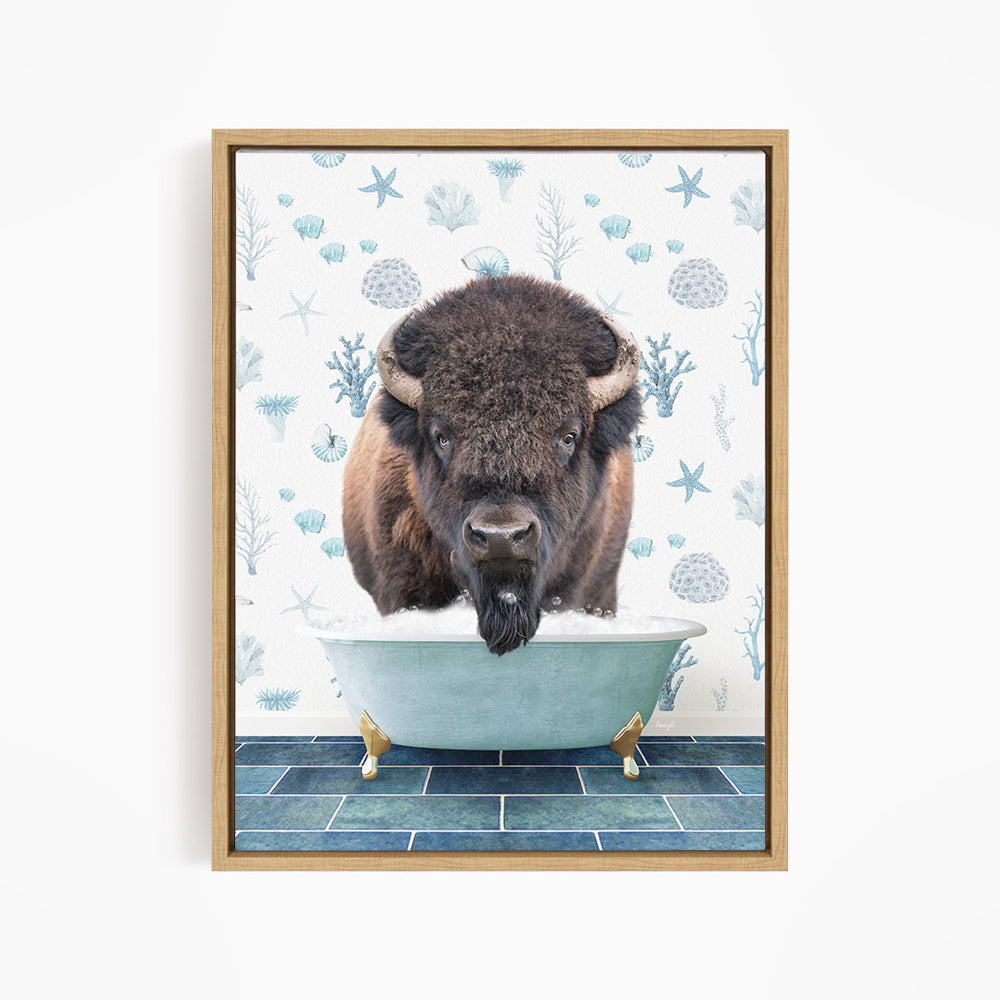 A buffalo is sitting in a bathtub filled with water, surrounded by blue and white floral patterns.