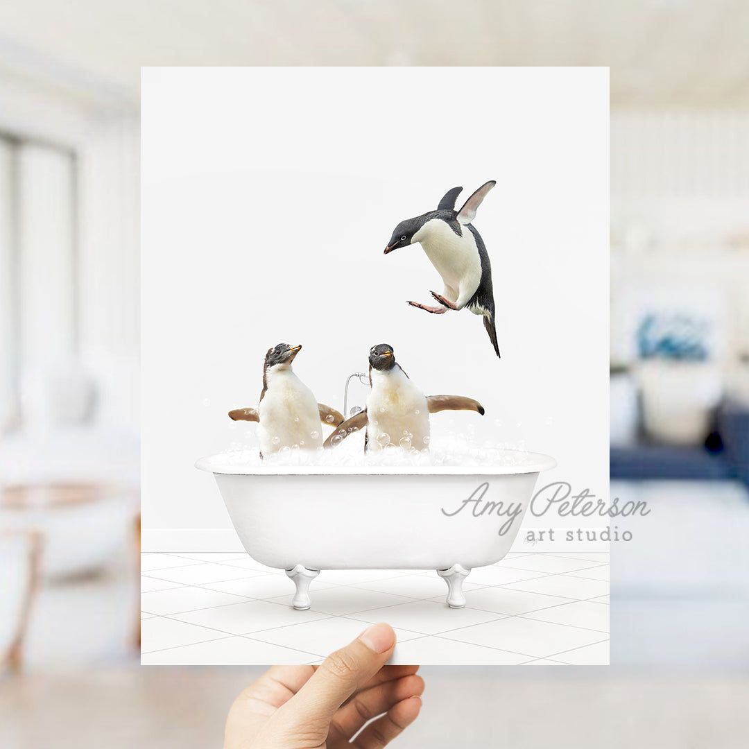 a hand holding up a card with penguins in a bathtub