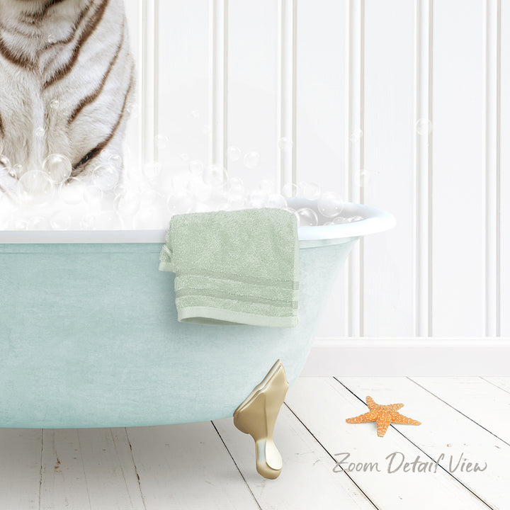 A white cat is sitting in a light blue bathtub filled with bubbles, with a green towel hanging on the side and a starfish on the floor.