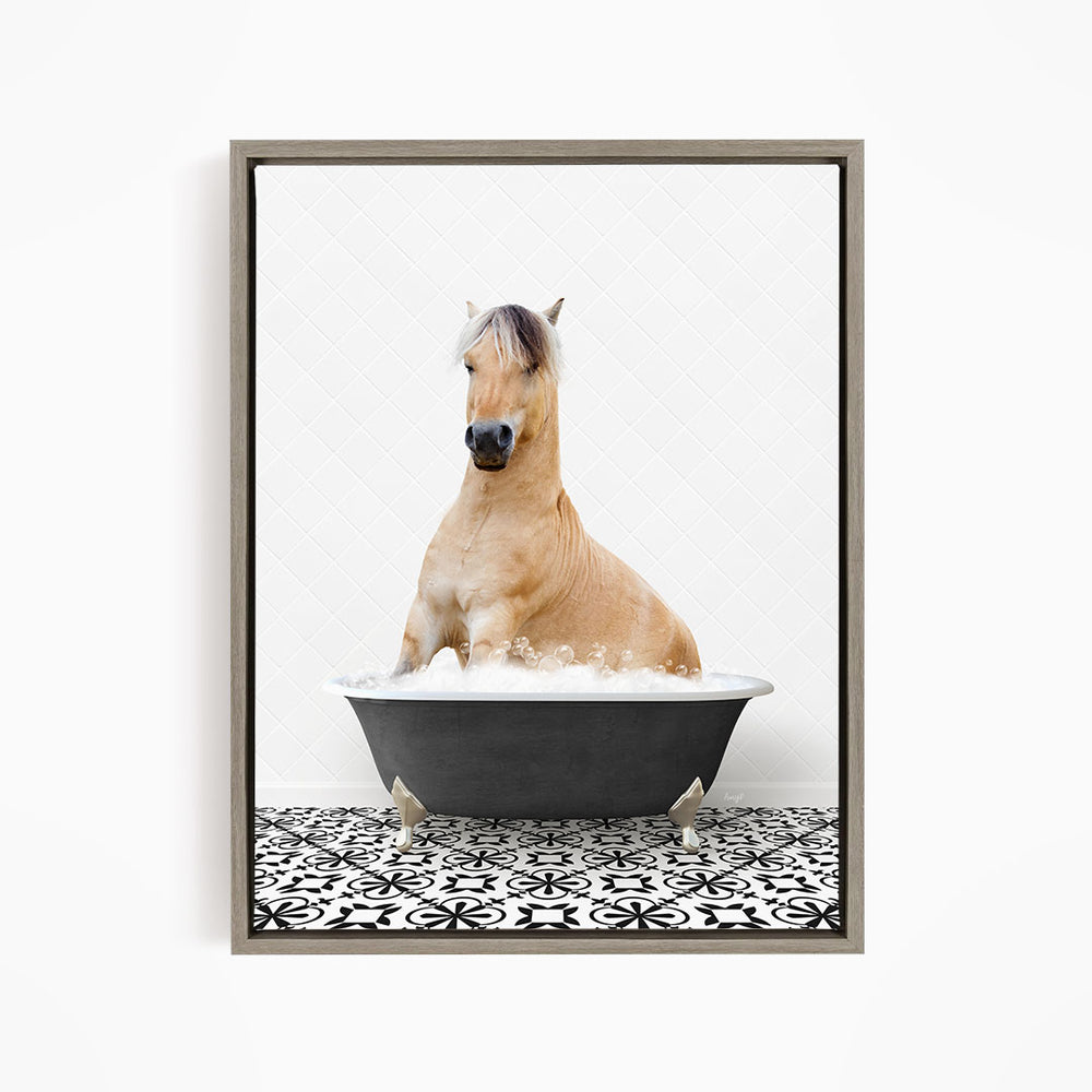 A light brown horse is sitting in a black bathtub filled with water, creating a whimsical and playful scene.