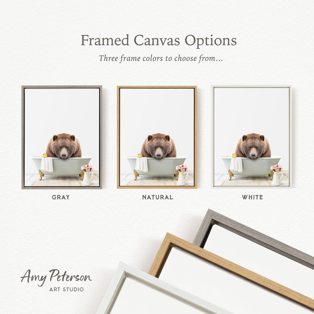 three framed canvas options, each featuring a brown bear in a bathtub. The options include a gray frame, a natural frame, and a white frame. The text above the images reads " framed Canvas Options" and "Three frame colors to choose from...".
