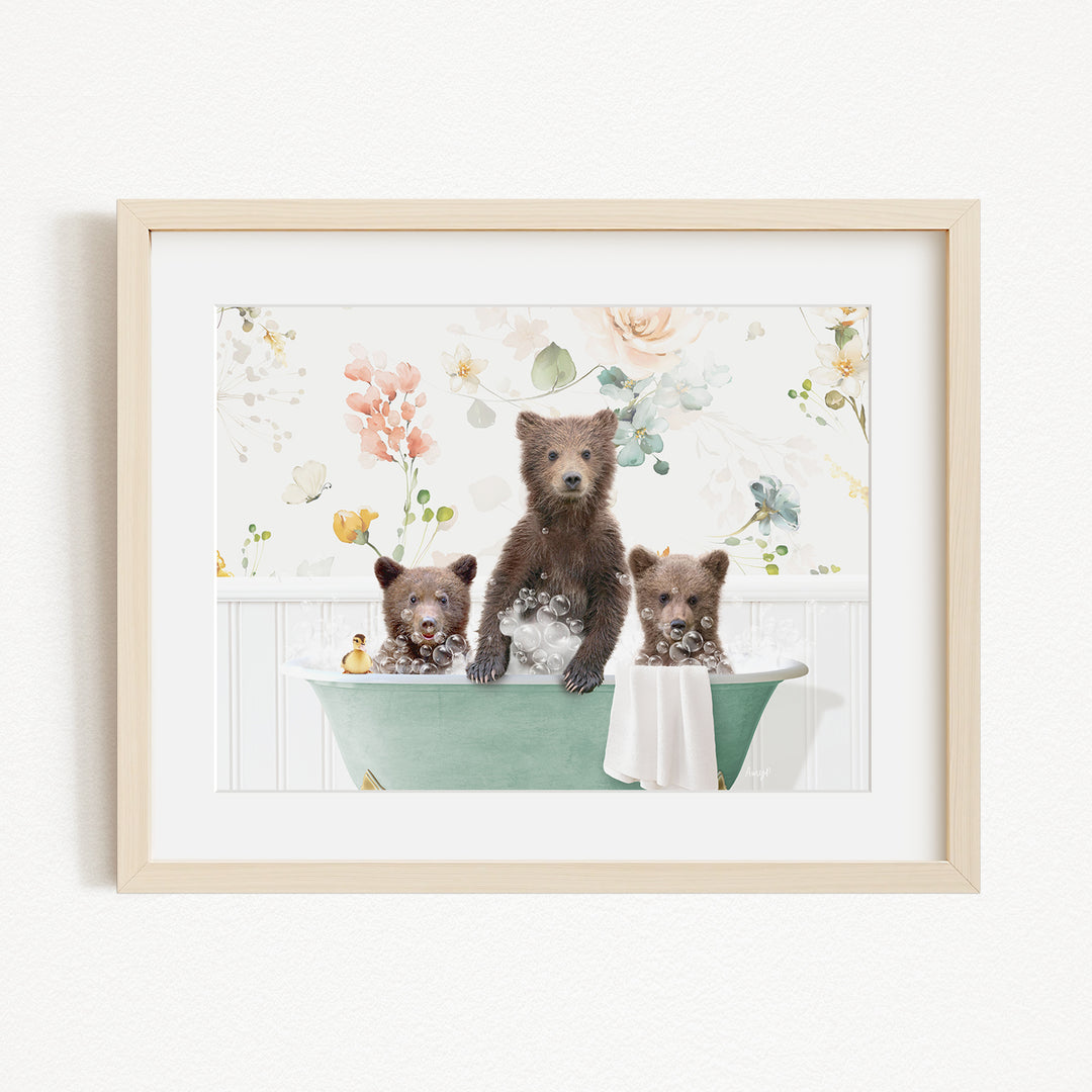 A framed image depicting three bears sitting in a green bathtub, surrounded by flowers and greenery.