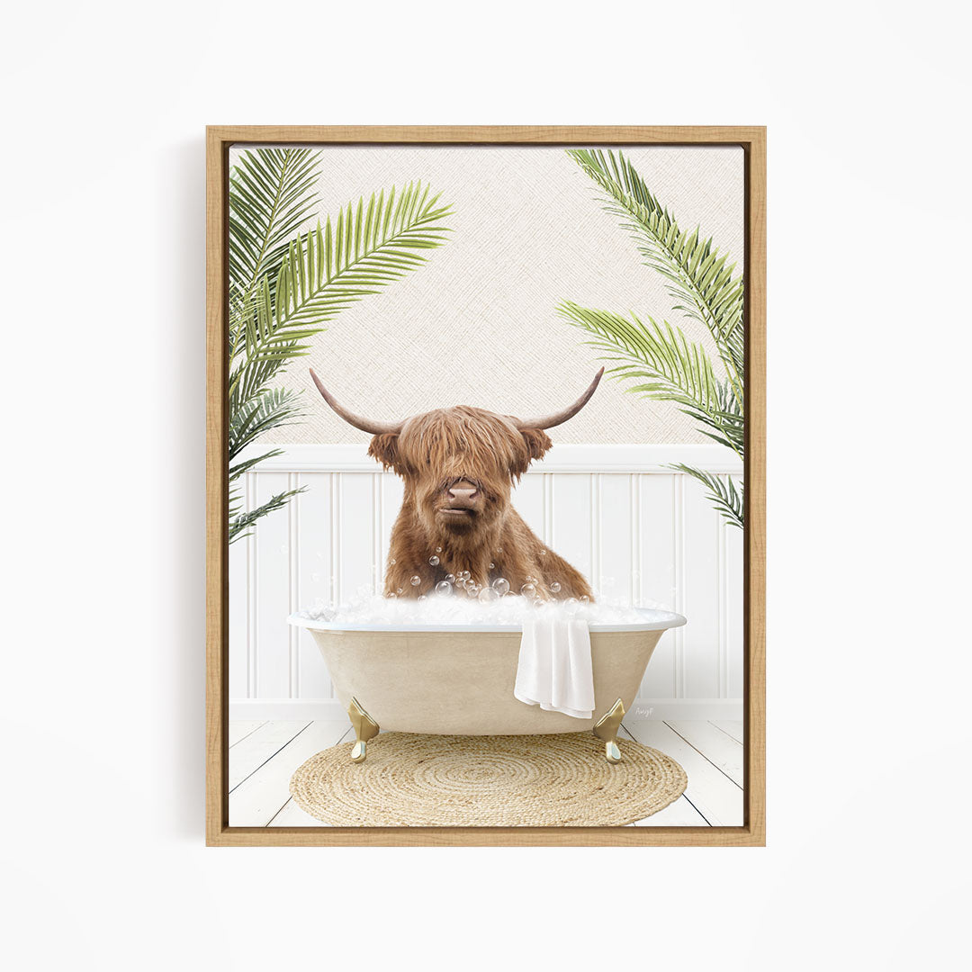 A brown cow with long horns is sitting in a white bathtub filled with water, surrounded by green palm leaves.
