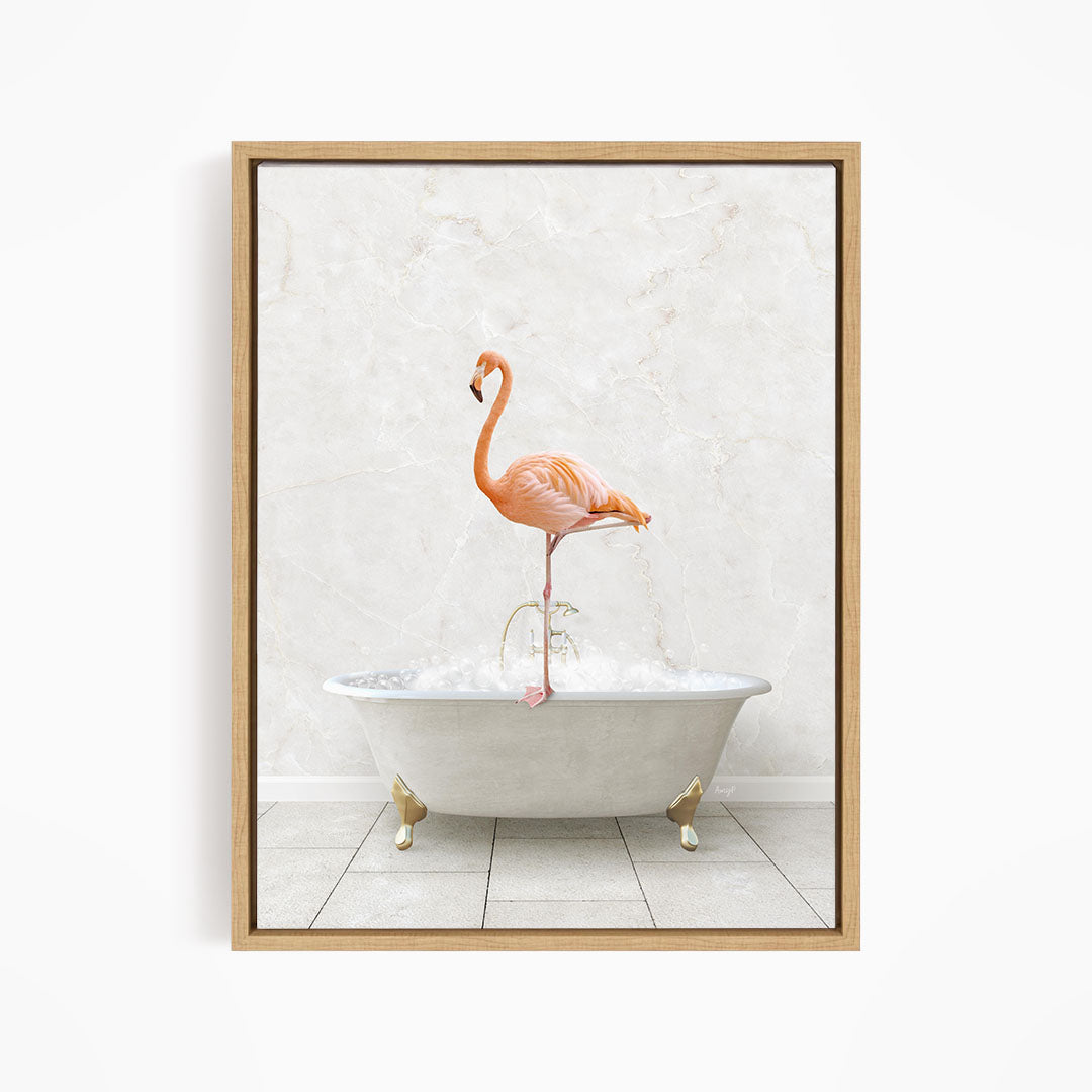 A pink flamingo standing on the edge of a white bathtub filled with bubbles.