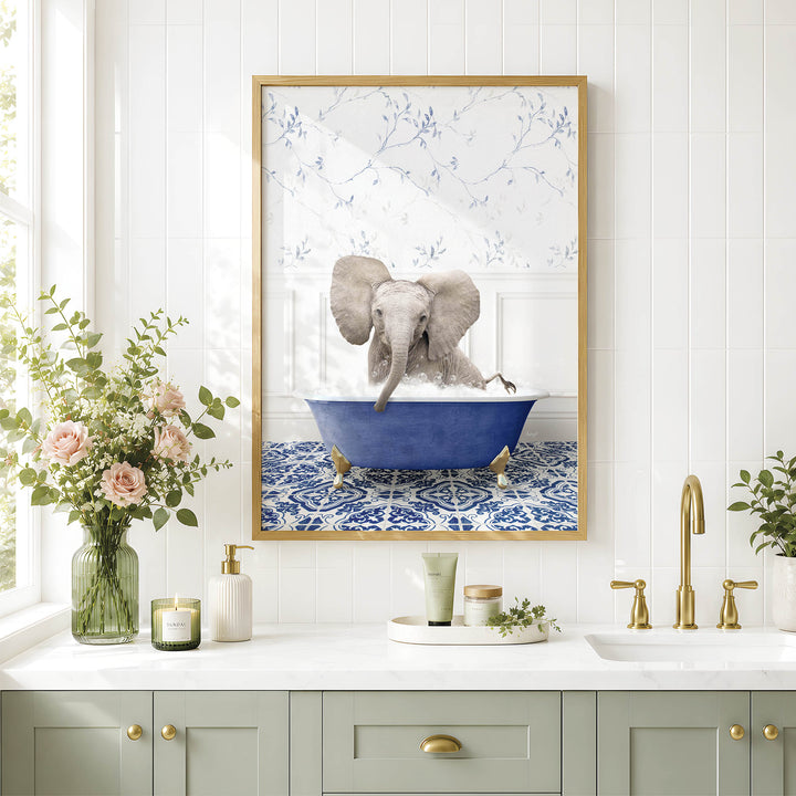 a bathroom scene with a framed picture of an elephant sitting in a blue bathtub, surrounded by flowers and a vase.
