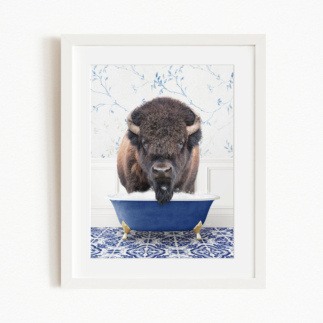 A buffalo with large horns is standing in a blue bathtub filled with water, creating a whimsical and humorous scene.