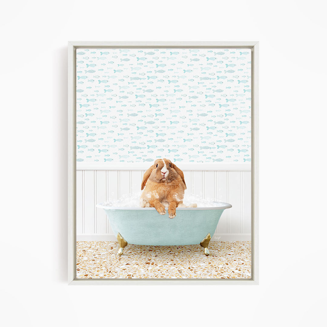 A brown rabbit sitting in a light blue bathtub filled with water, surrounded by a pattern of small fish.