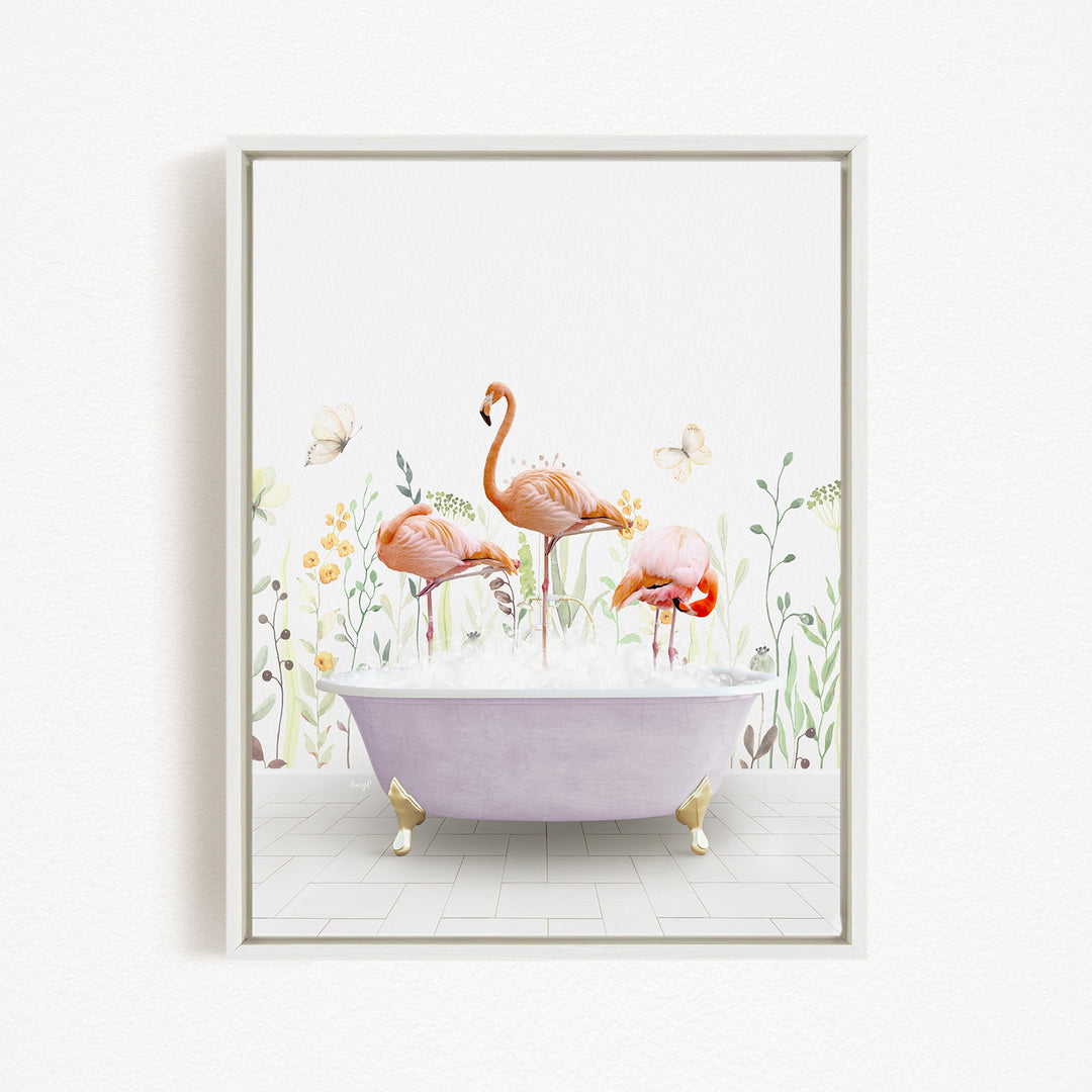 A framed illustration depicting three flamingos standing in a bathtub filled with bubbles, surrounded by flowers and butterflies.