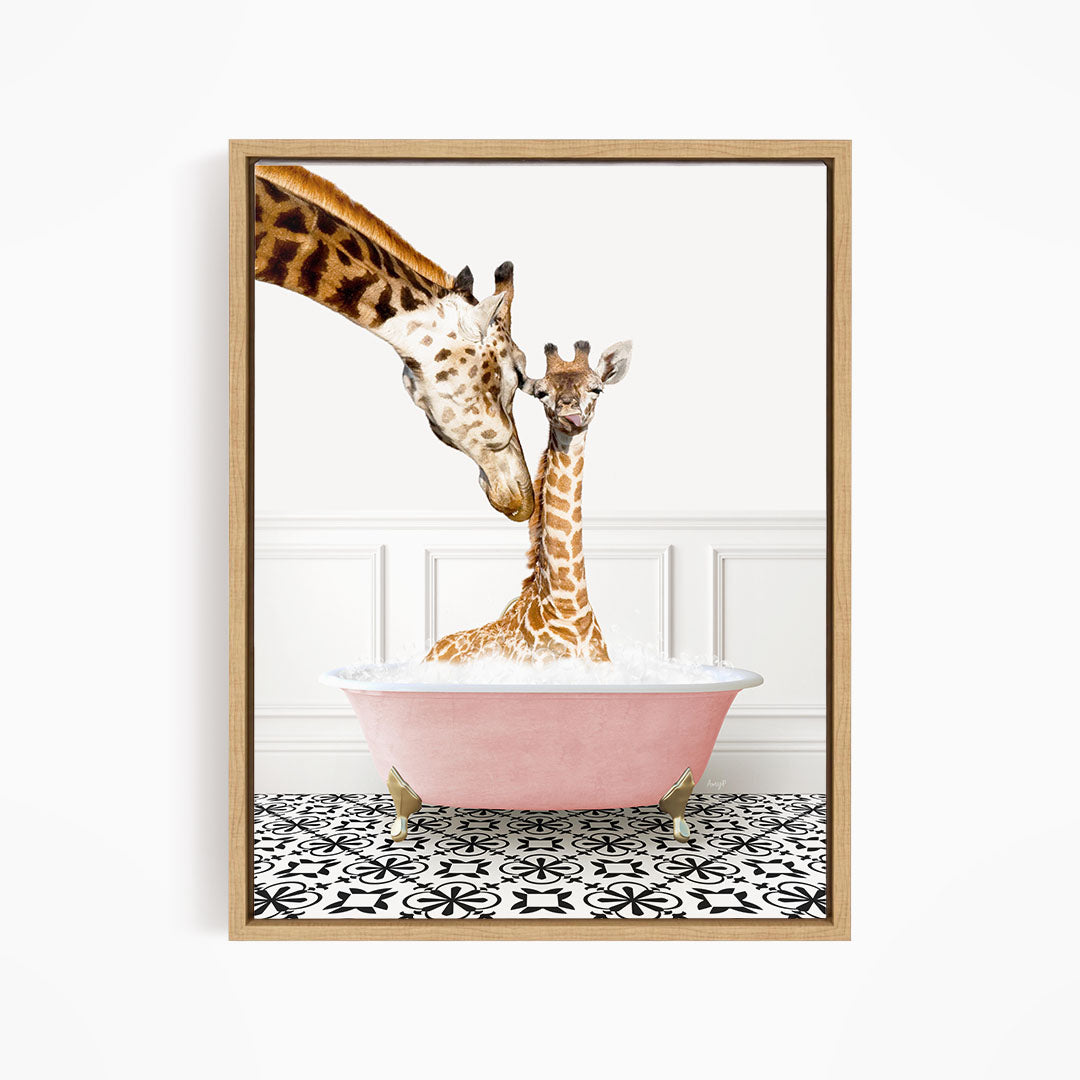 A mother giraffe and her baby giraffe are sitting together in a pink bathtub, with the mother gently licking her baby.