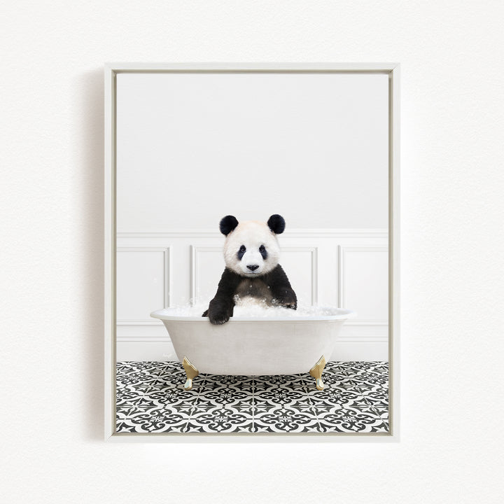 A panda bear sitting in a white bathtub filled with bubbles, surrounded by a black and white patterned floor.