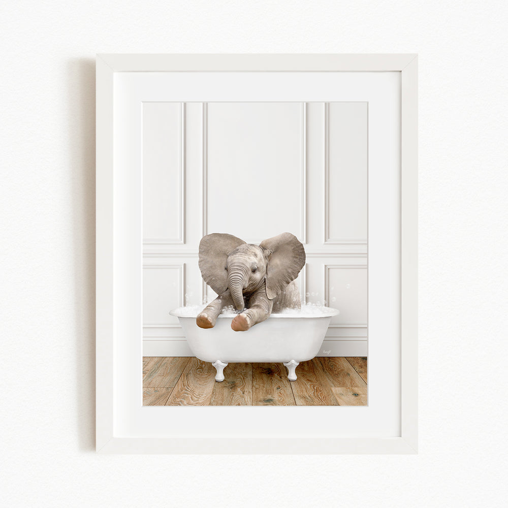 A baby elephant sitting in a white bathtub, enjoying a bath.