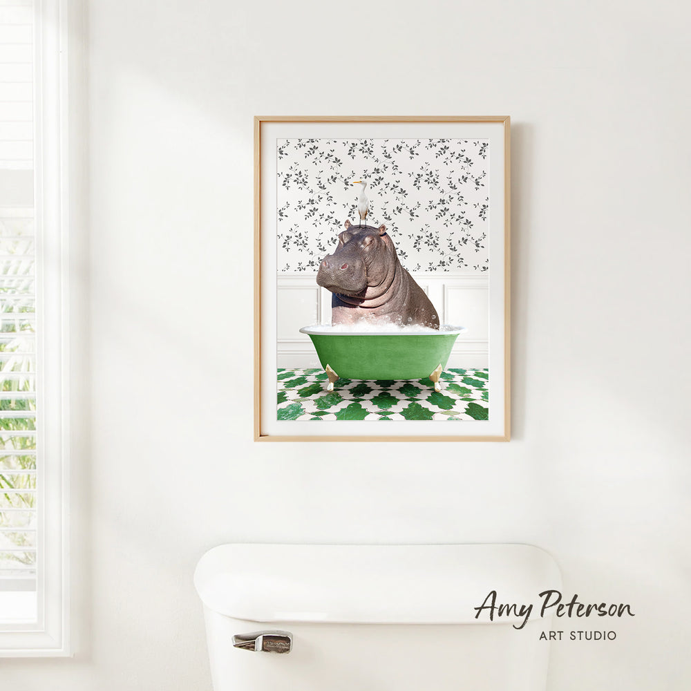 A framed image of a hippopotamus sitting in a green bathtub, with a patterned wall behind it.