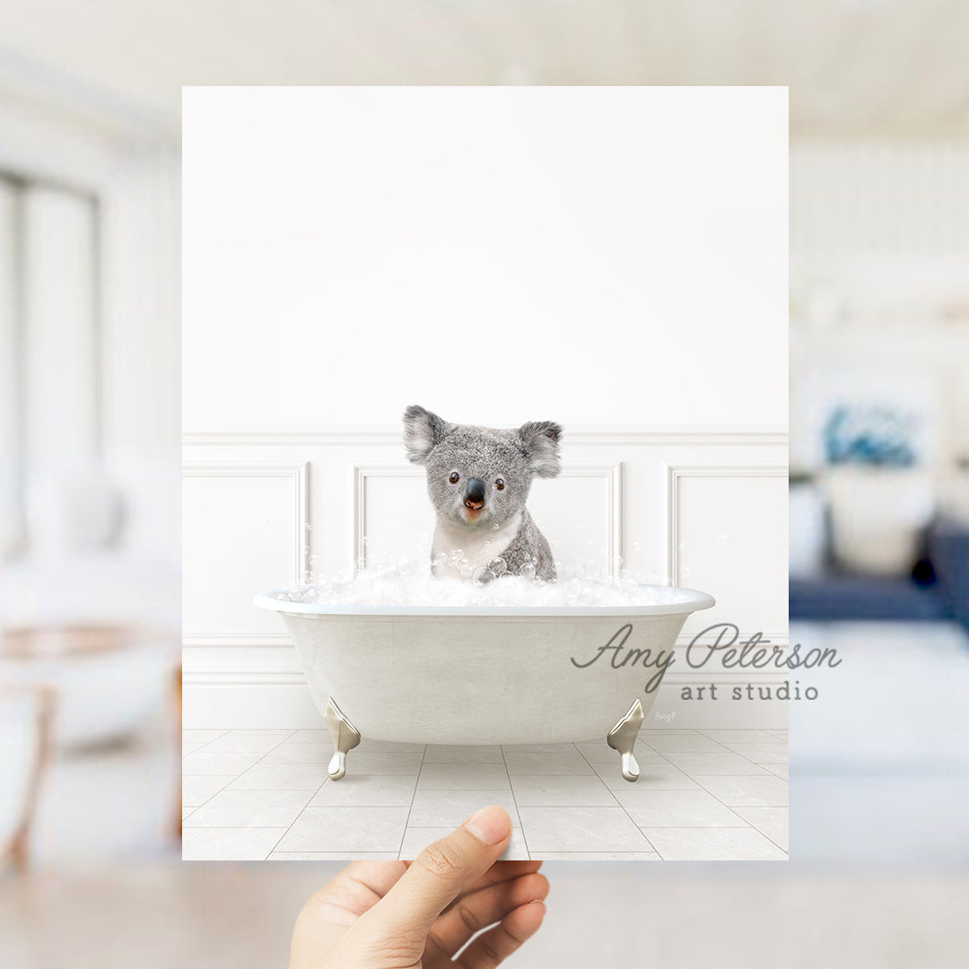 a hand holding a card with a picture of a koala in a bathtub