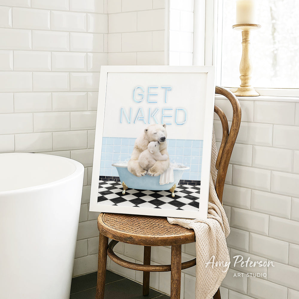 A framed image of a polar bear sitting in a bathtub, with the text "GET NAKED" displayed on the frame.