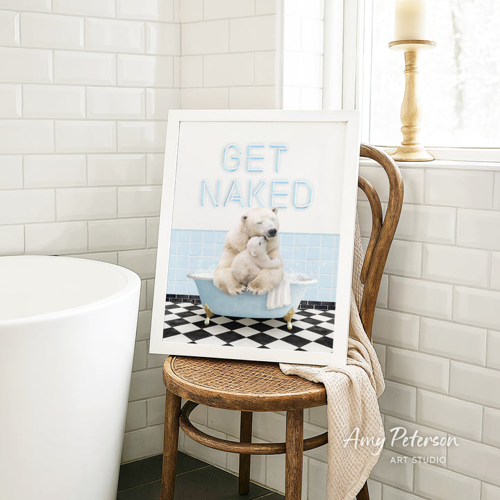 A framed image of a polar bear sitting in a bathtub, with the text "GET NAKED" displayed on the frame.