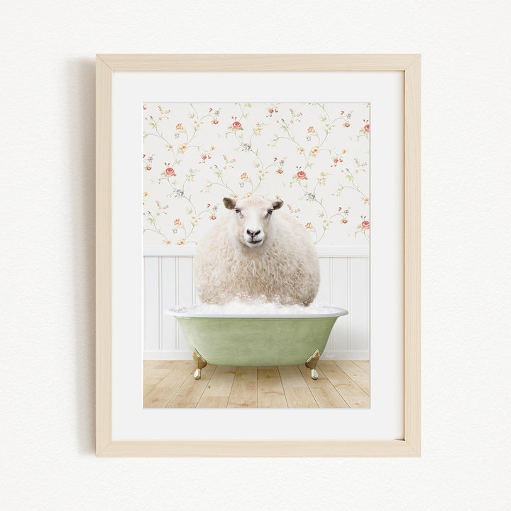 A fluffy white sheep sits in a green bathtub, surrounded by a floral wallpaper.