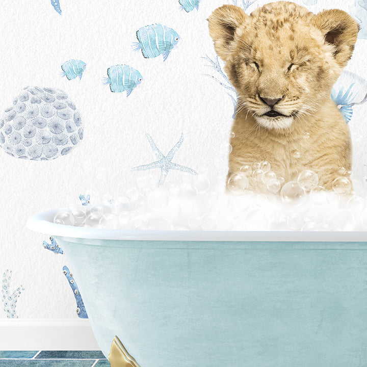 a baby lion sitting in a bathtub filled with bubbles