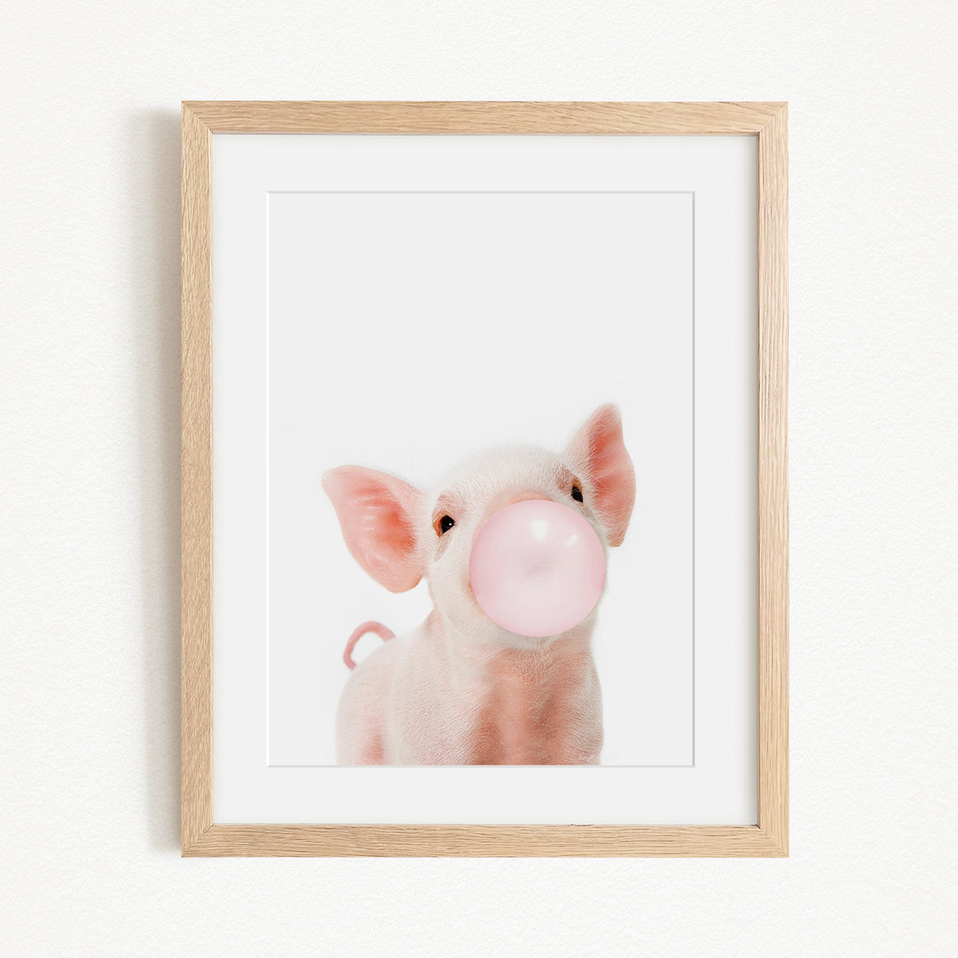 A cute pig blowing a bubble with a pink bubble gum bubble.