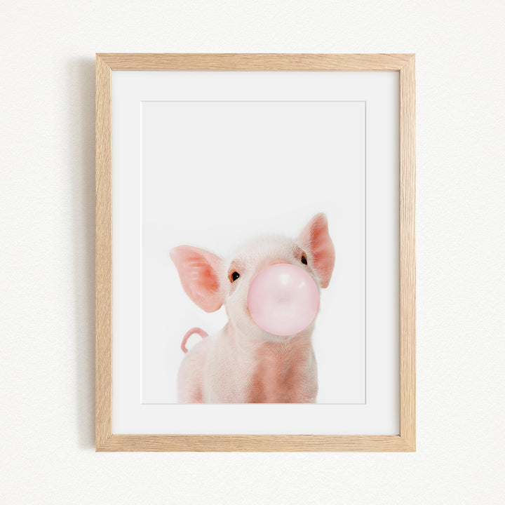 A cute pig blowing a bubble with a pink bubble gum bubble.