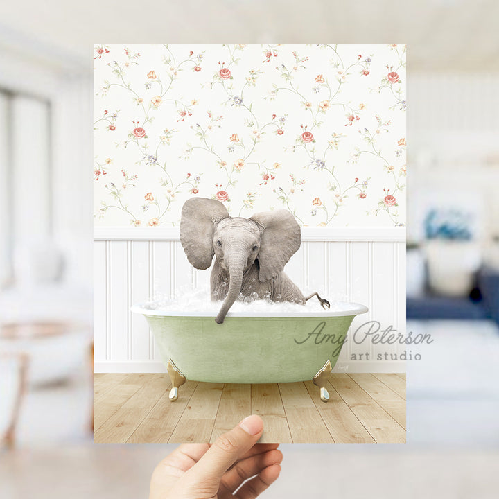 a person holding up a picture of an elephant in a bathtub