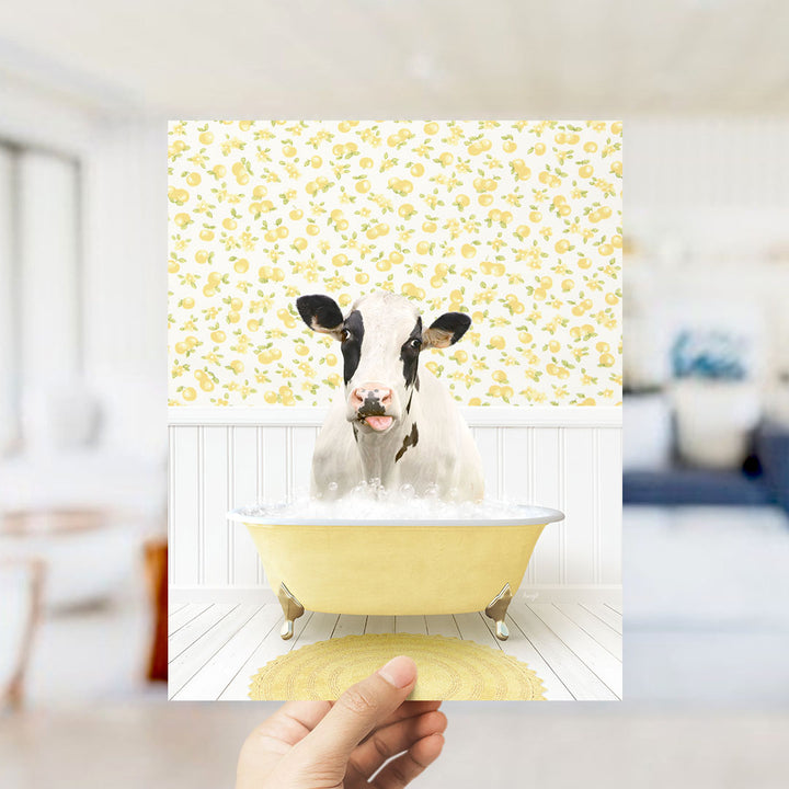 A cow is sitting in a yellow bathtub filled with bubbles, surrounded by a yellow and white patterned wall.