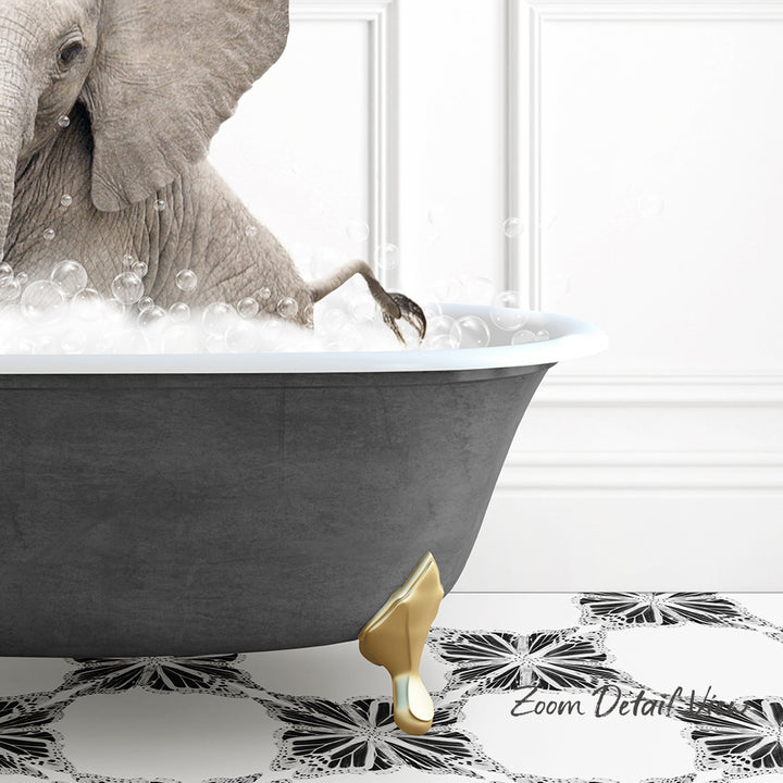 A gray elephant is sitting in a bathtub filled with bubbles, with its foot resting on the edge of the tub.