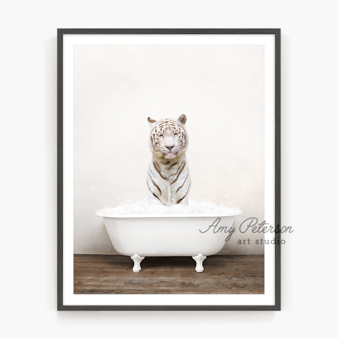 a white tiger is sitting in a bathtub