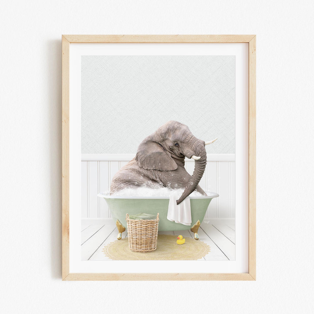 A gray elephant is sitting in a green bathtub filled with bubbles, surrounded by a yellow rubber duck and a wicker basket.