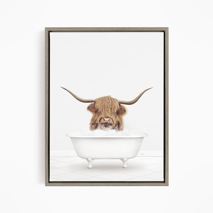 A Highland cow with long horns is sitting in a white bathtub filled with water, appearing to enjoy the bath.