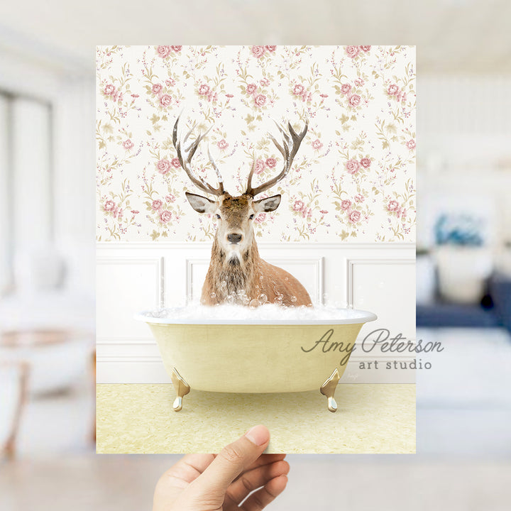 a hand holding up a card with a picture of a deer in a bathtub