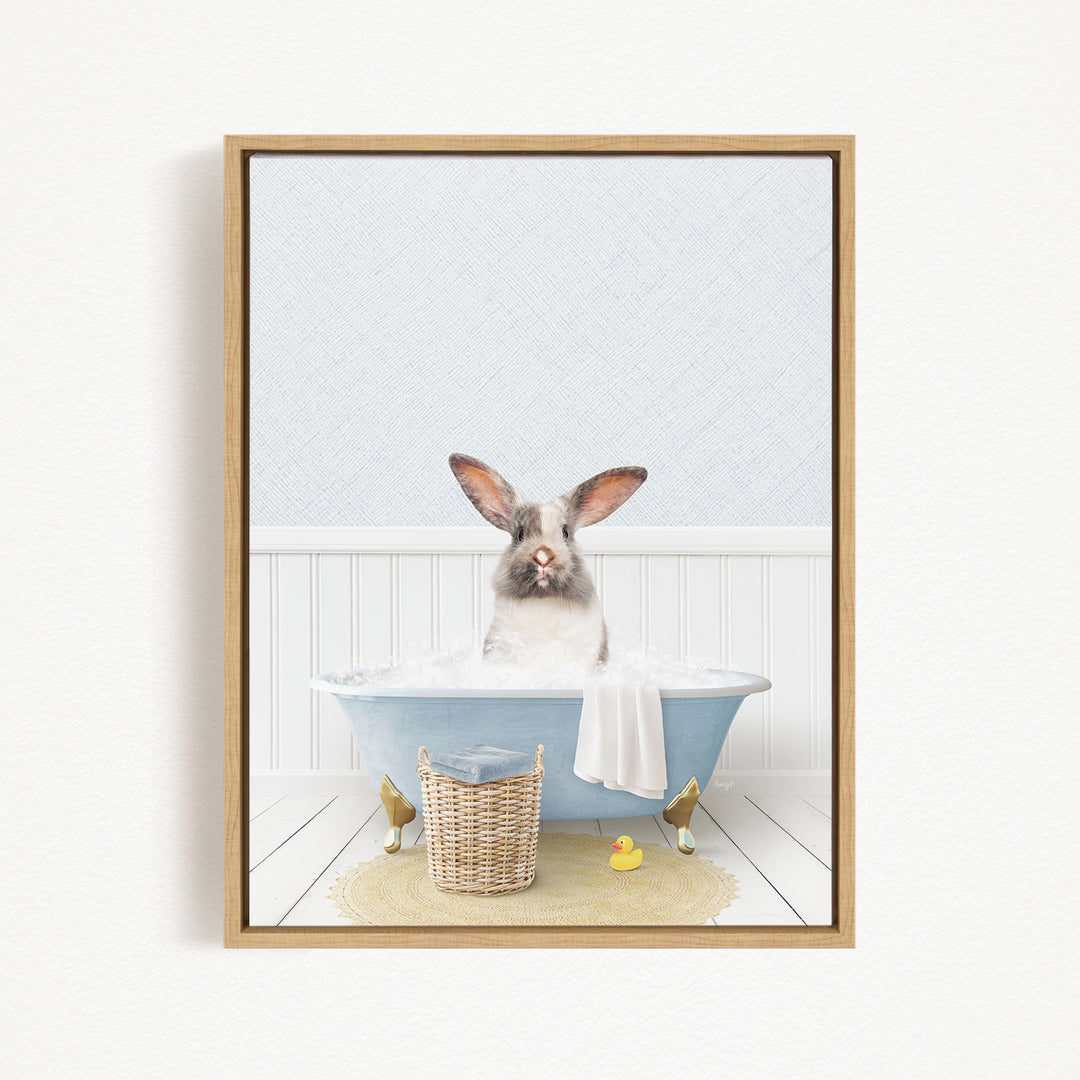 A fluffy white rabbit sits in a blue bathtub filled with water, surrounded by rubber ducks and a basket.