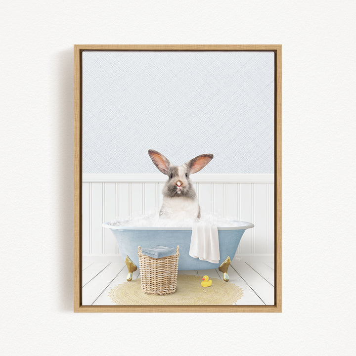 A fluffy white rabbit sits in a blue bathtub filled with water, surrounded by rubber ducks and a basket.