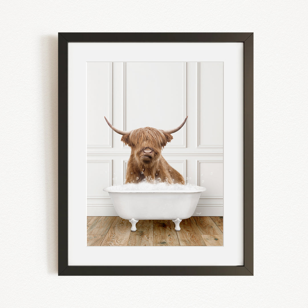 A brown cow with long horns is sitting in a white bathtub filled with water, appearing to enjoy the bath.