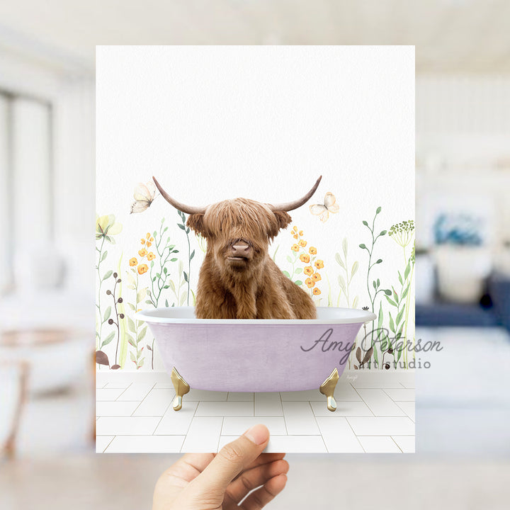 a hand holding up a card with a picture of a cow in a bathtub