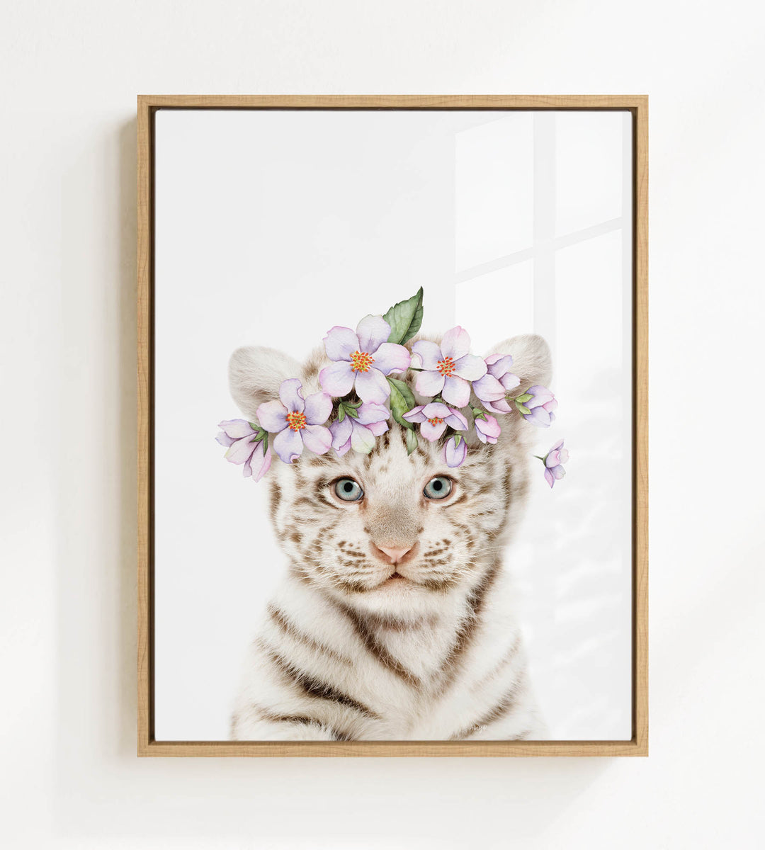 A young tiger cub wearing a floral headpiece with purple flowers.