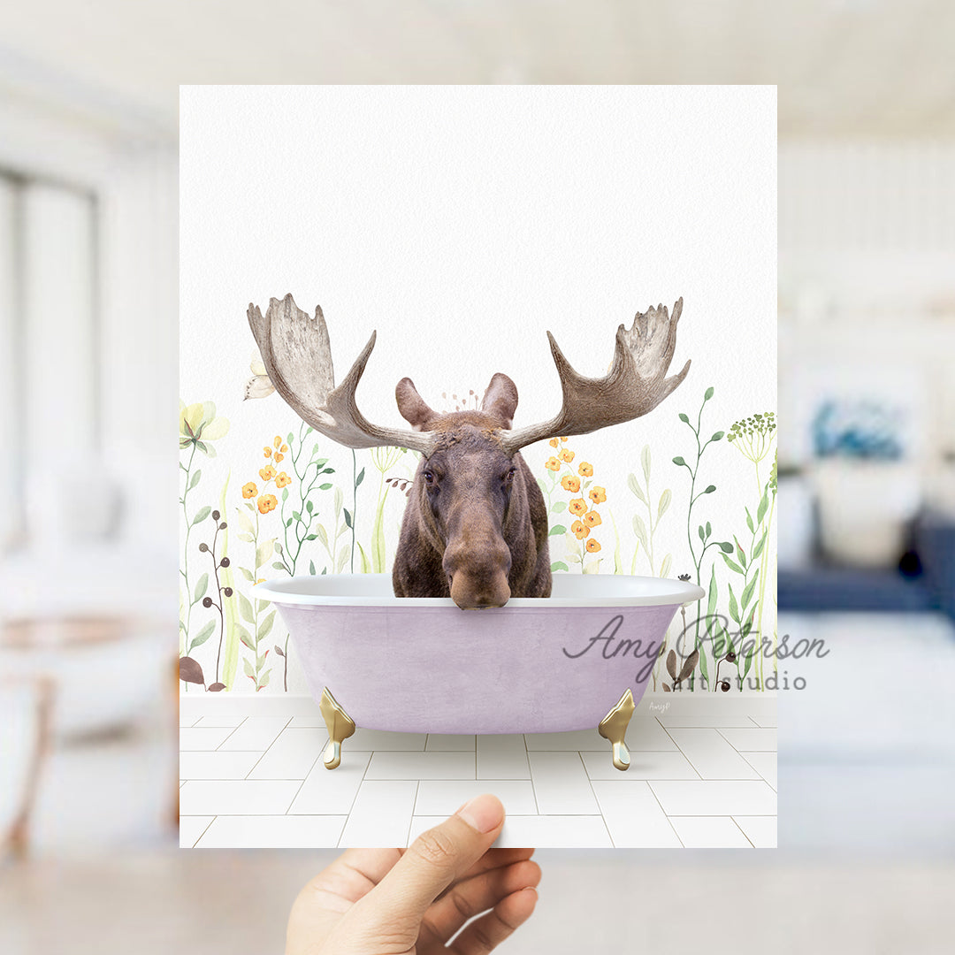 a person holding up a card with a moose in a bathtub