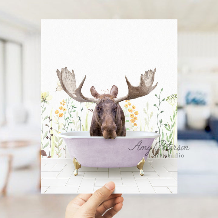 a person holding up a card with a moose in a bathtub