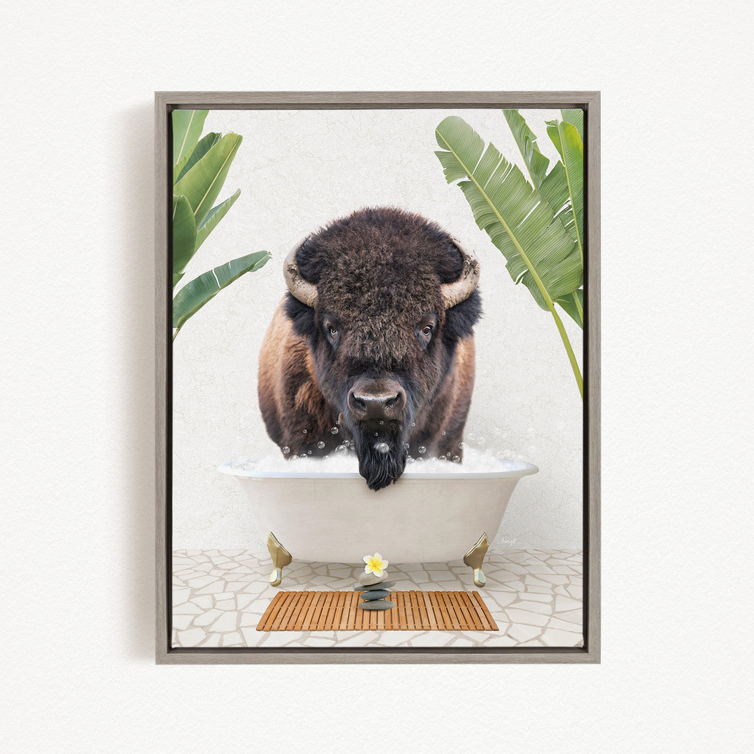 A buffalo is sitting in a bathtub filled with water, surrounded by tropical plants and a wooden mat on the floor.
