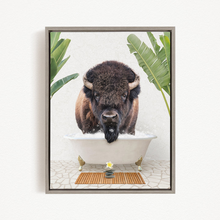 A buffalo is sitting in a bathtub filled with water, surrounded by tropical plants and a wooden mat on the floor.