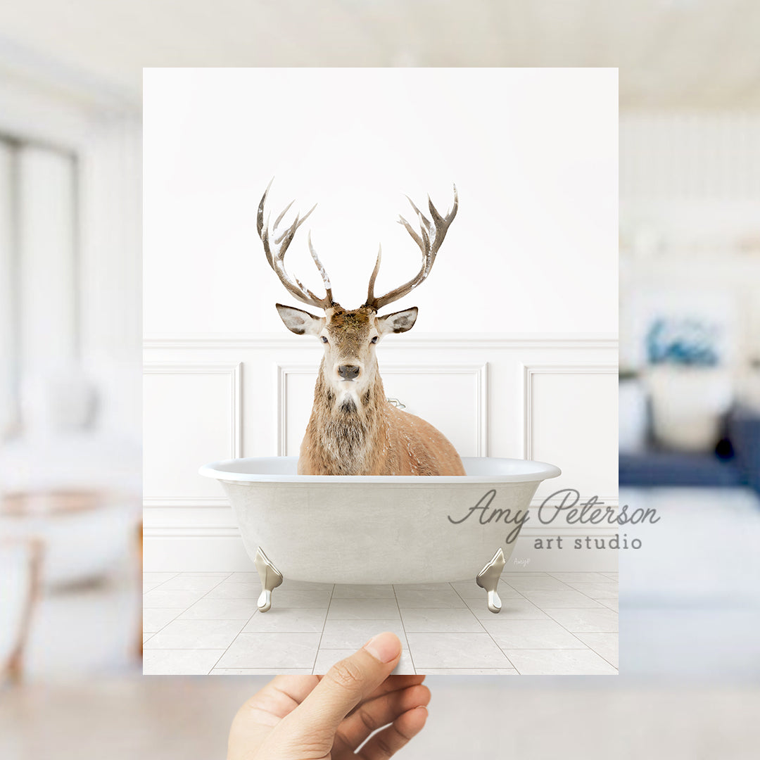 a hand holding up a card with a picture of a deer in a bathtub