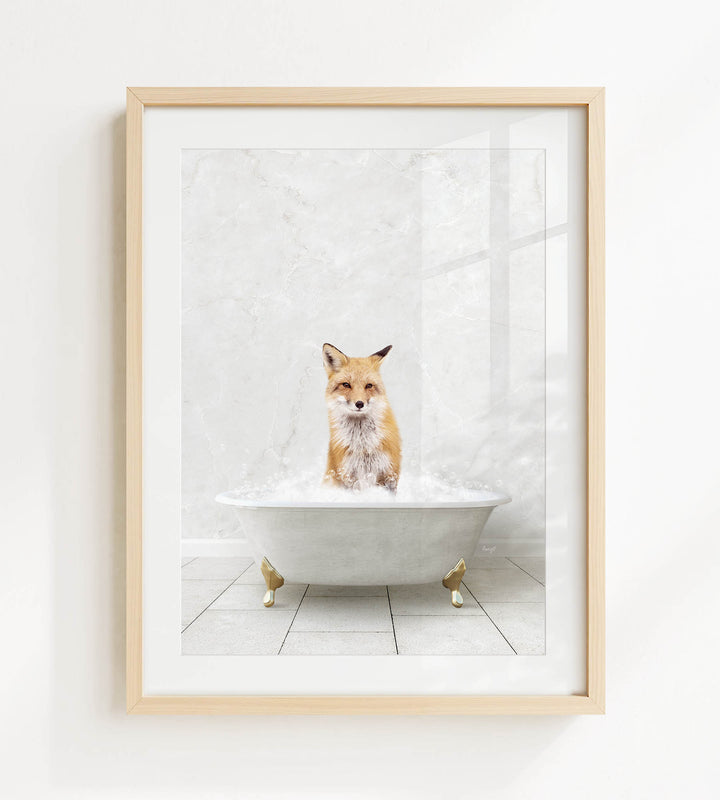 A fox is sitting in a white bathtub filled with bubbles, looking directly at the camera.