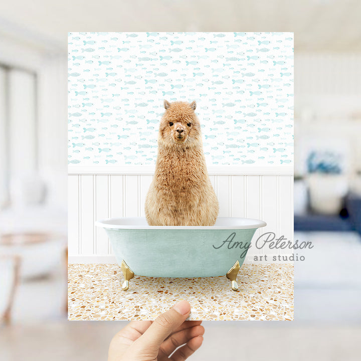 a hand holding a card with a picture of a llama in a bathtub