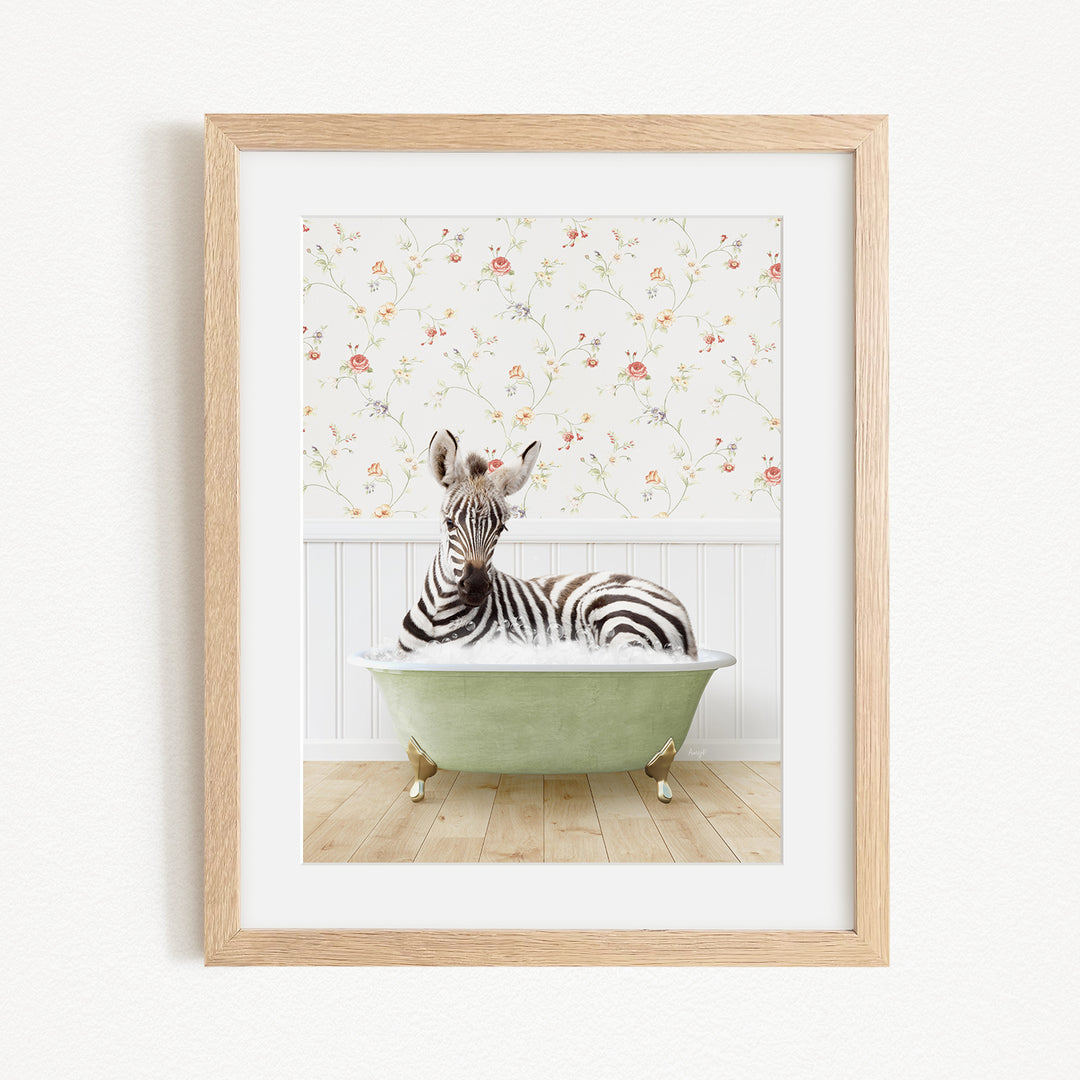 A zebra is sitting in a green bathtub, surrounded by a floral wallpaper.