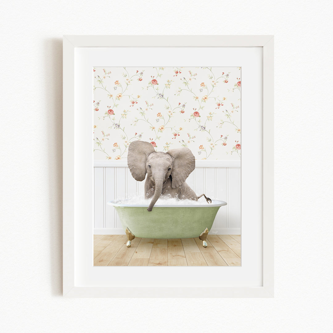 A gray elephant is sitting in a green bathtub, with its trunk in the water, against a floral wallpaper background.