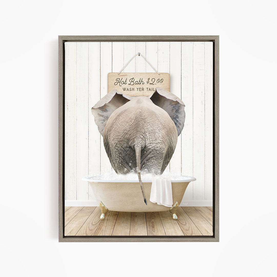A framed image depicting an elephant standing in a bathtub, with a sign above it that reads "Hot Bath $2.00 Wash Your Tail".