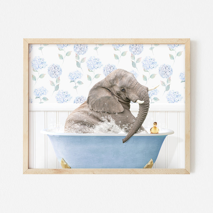 an elephant taking a bath in a blue bathtub